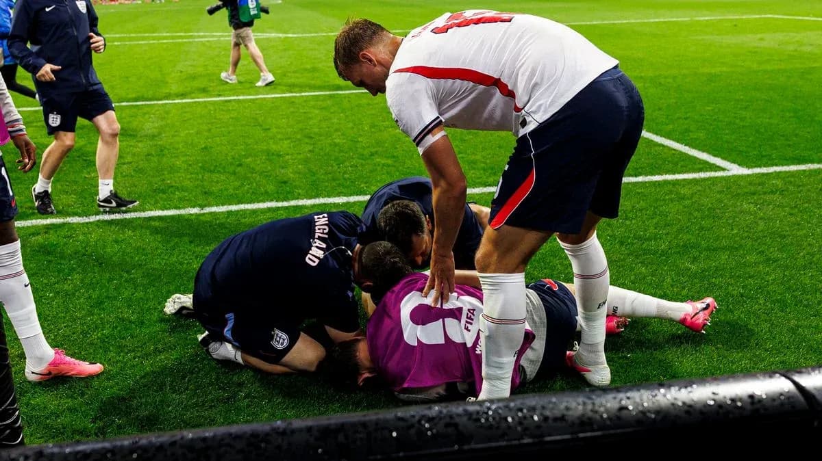Players and staff attending to an injured teammate