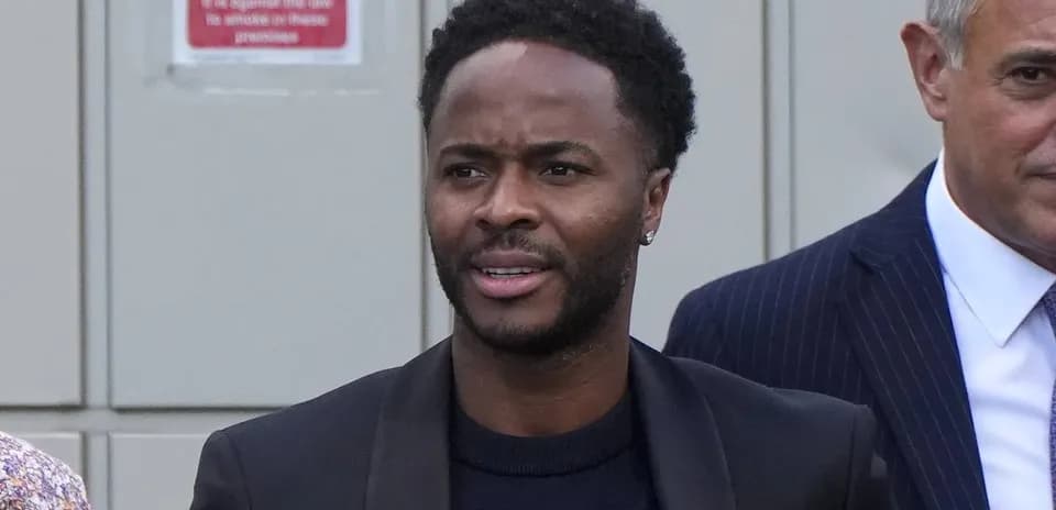 Raheem Sterling walking with another man outdoors