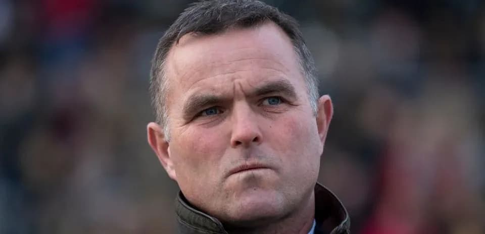 A man looking serious in a crowd