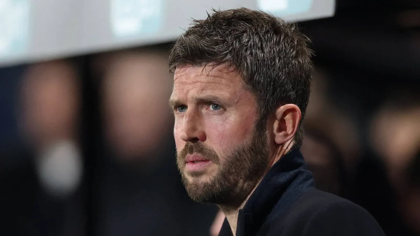 Football coach observing match from sidelines