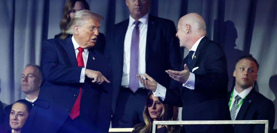 Two men talking while seated in audience