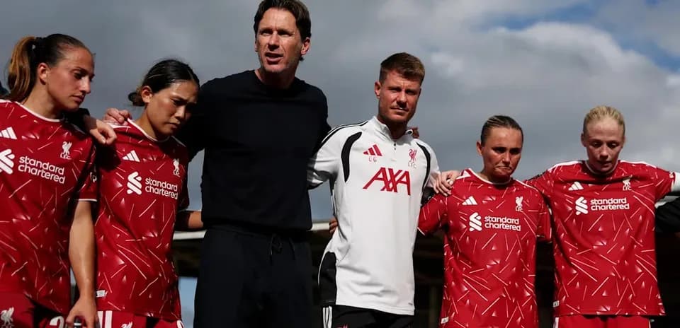Liverpool women's team in huddle with coaches
