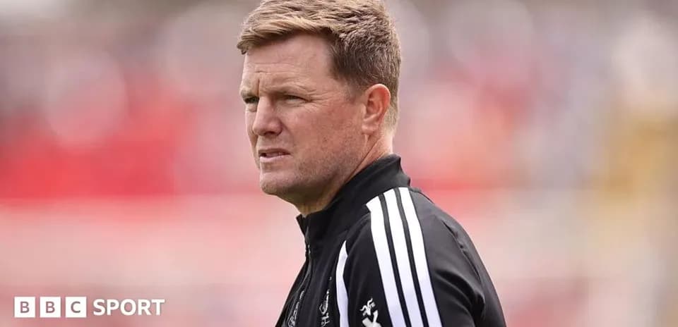 Men's football manager observing match from sidelines