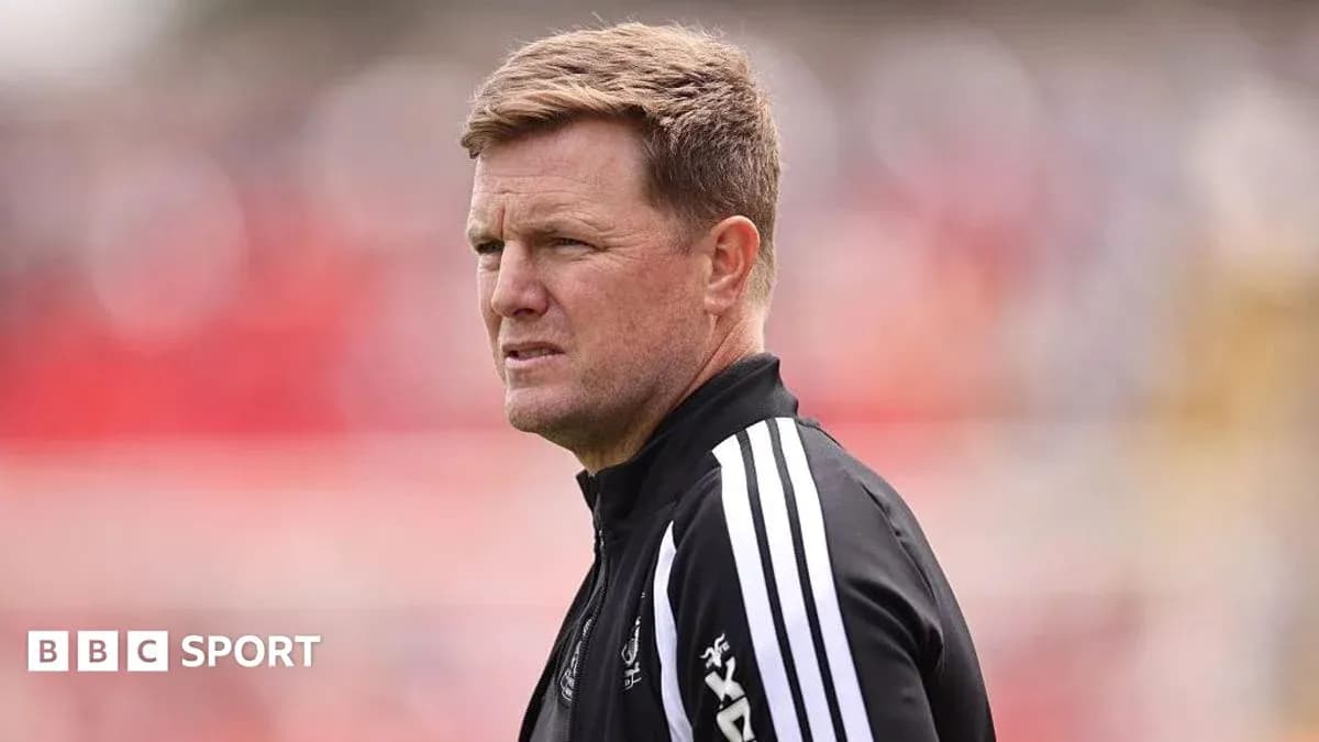 Men's football manager observing match from sidelines