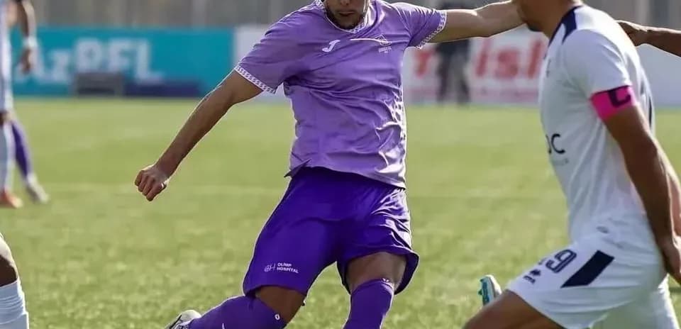 Neftçi Baku futbolçusu topa zərbə vurur