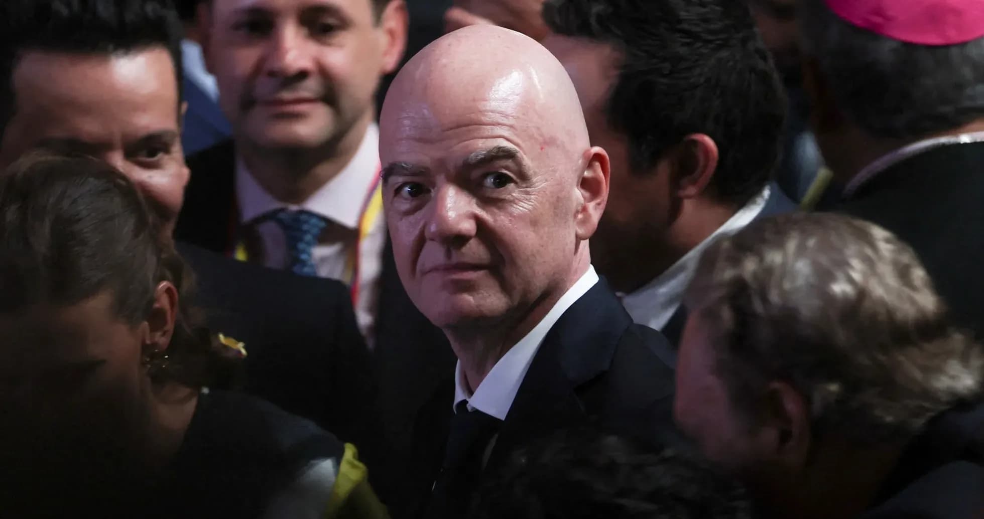 FIFA president surrounded by people at event