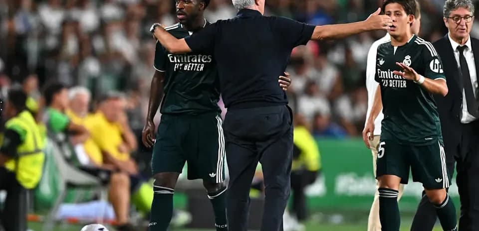 Real Madrid players interacting with coach during match