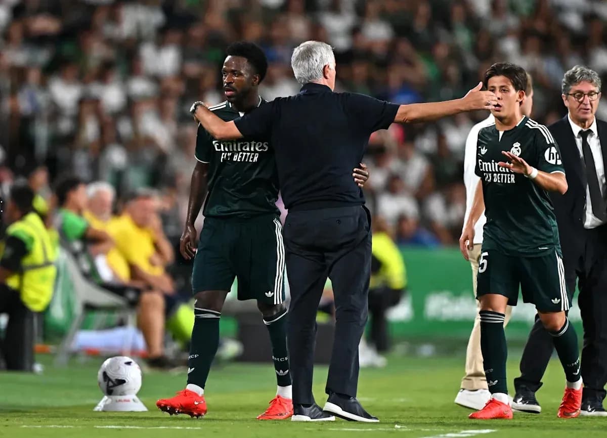 Real Madrid players interacting with coach during match