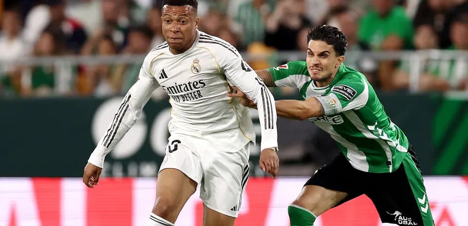 Mbappé dribbling past defender during match