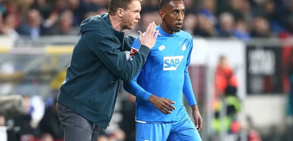 Coach instructing player during match on sideline