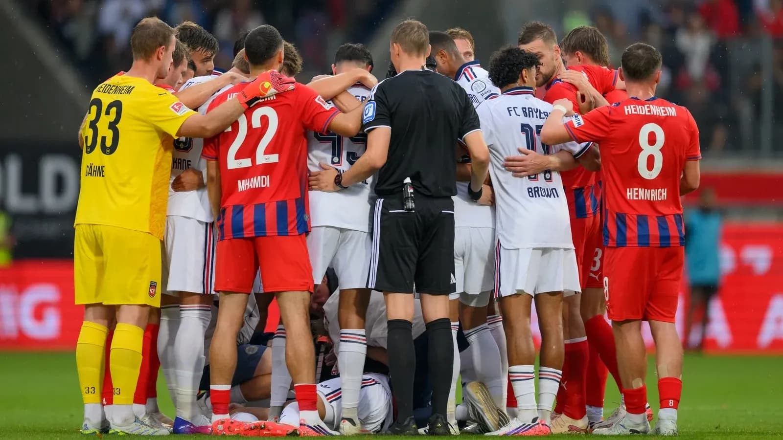 Players from both teams huddled during match incident