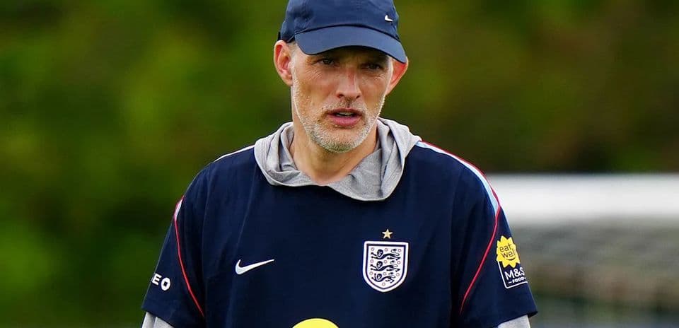 Football coach observing players during training session