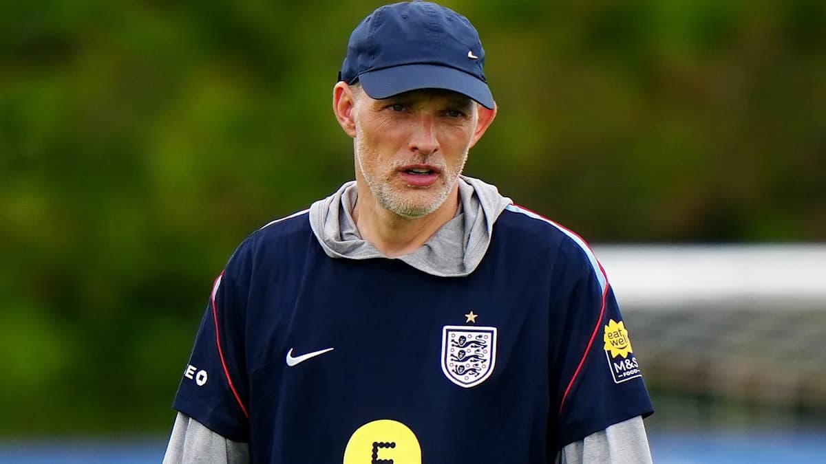 Football coach observing players during training session
