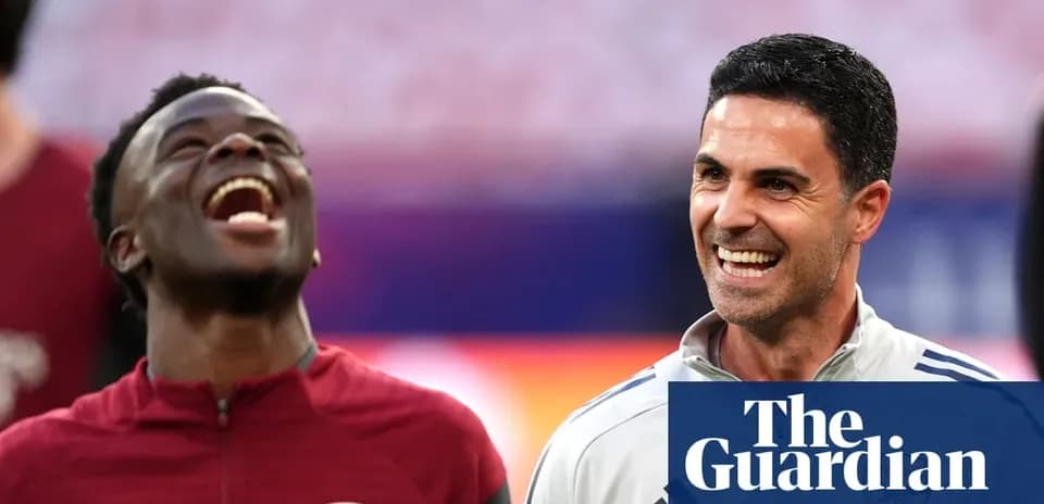 Two Arsenal players smiling during warm-up session