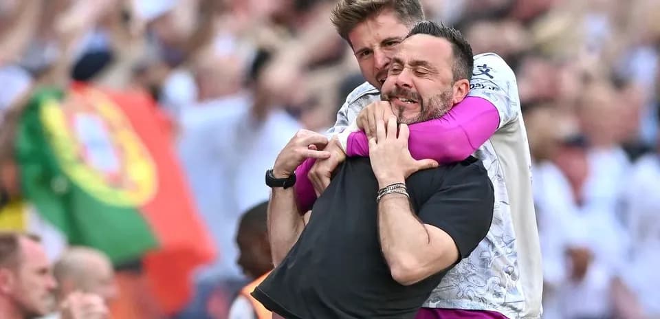 Coaches celebrating together on the sidelines