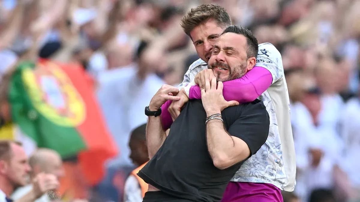 Coaches celebrating together on the sidelines