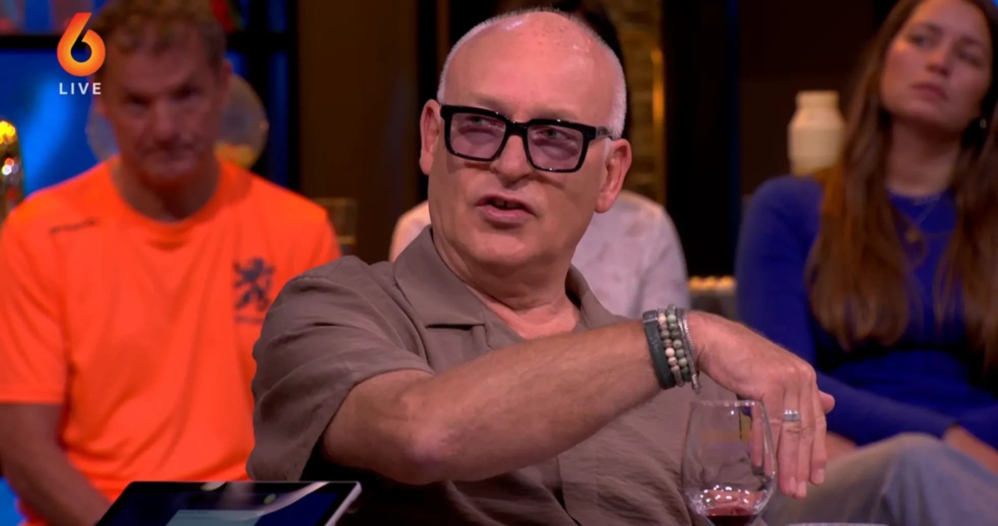 Man speaking during a talk show with guests