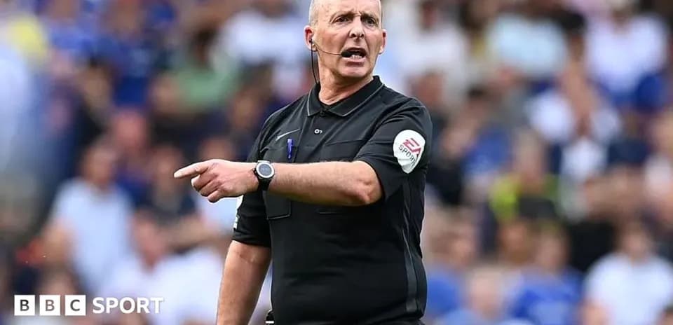 Referee gesturing during a football match