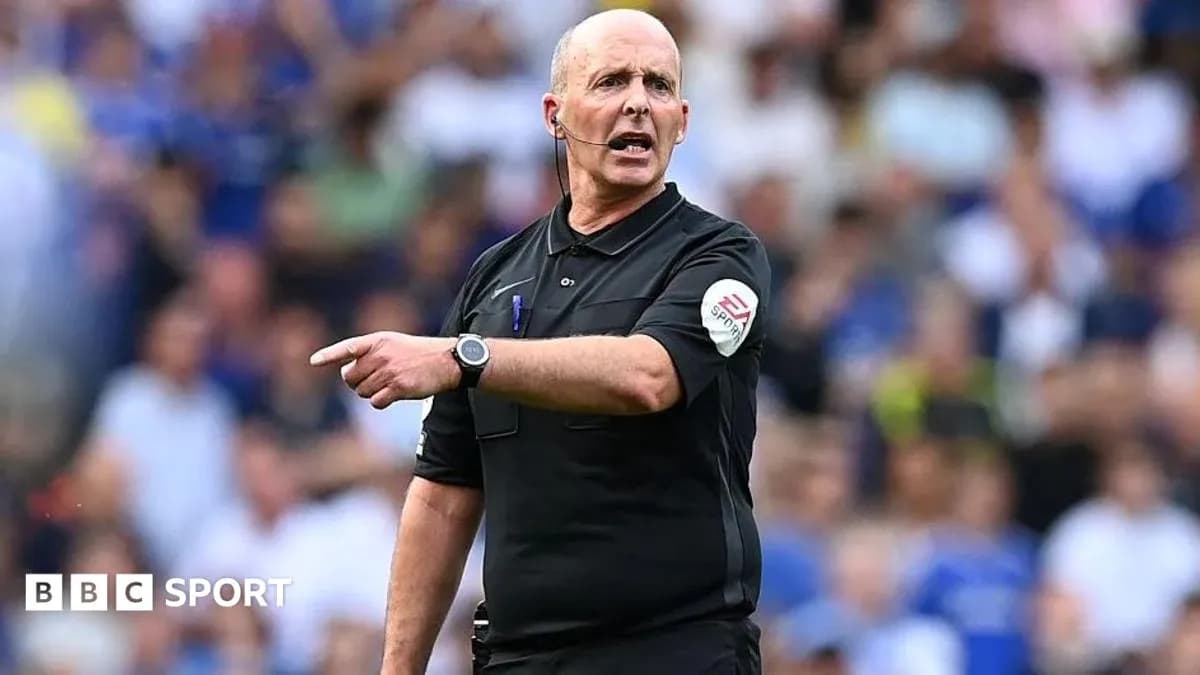 Referee gesturing during a football match