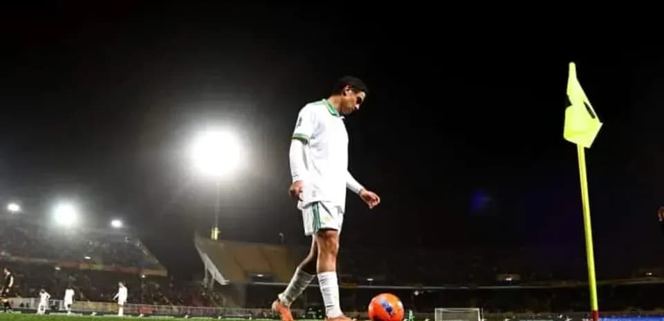 Player preparing for corner kick at night match