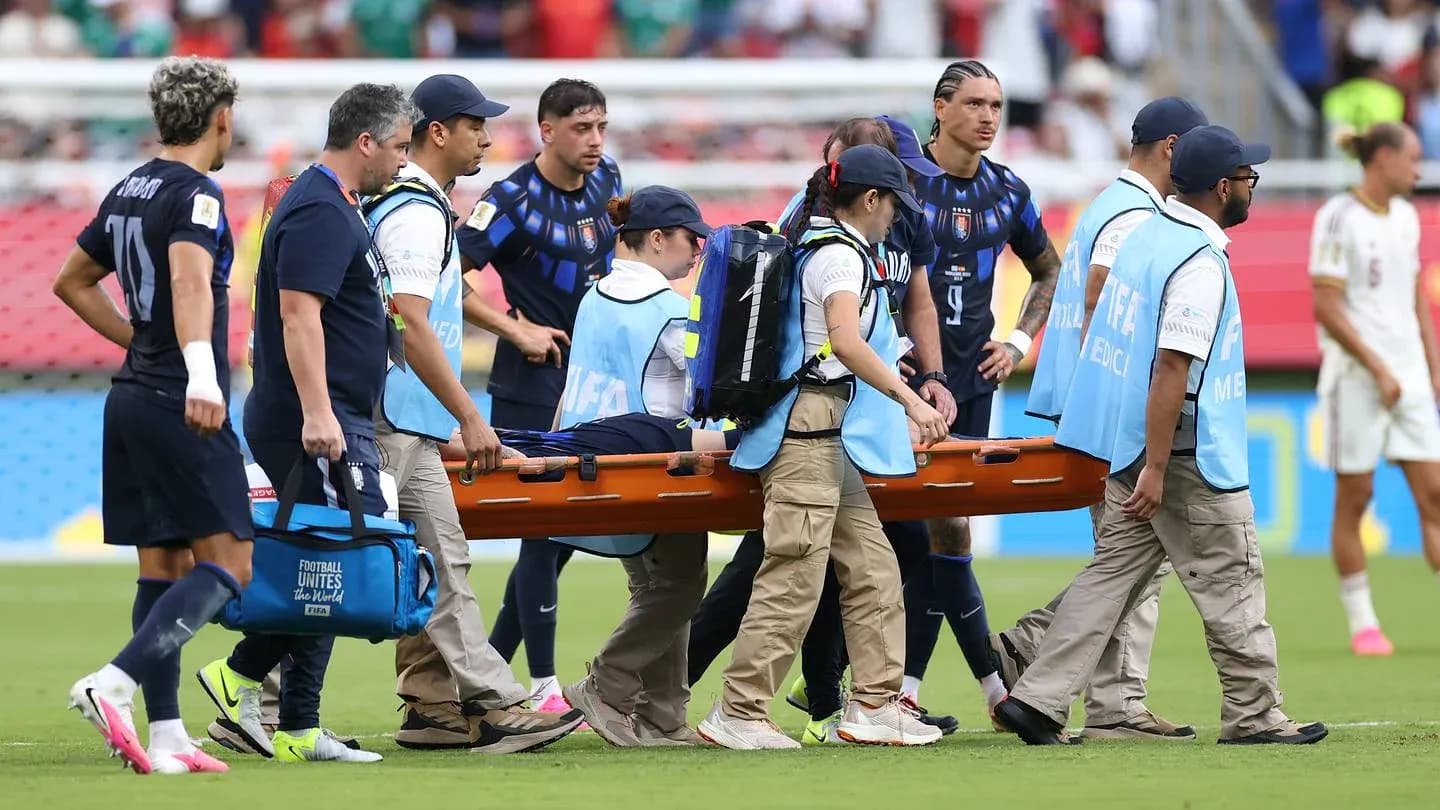 Medical team carrying injured player on stretcher