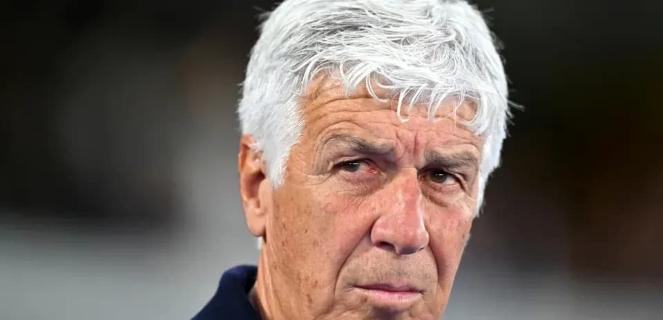 Football coach looking intently during a match