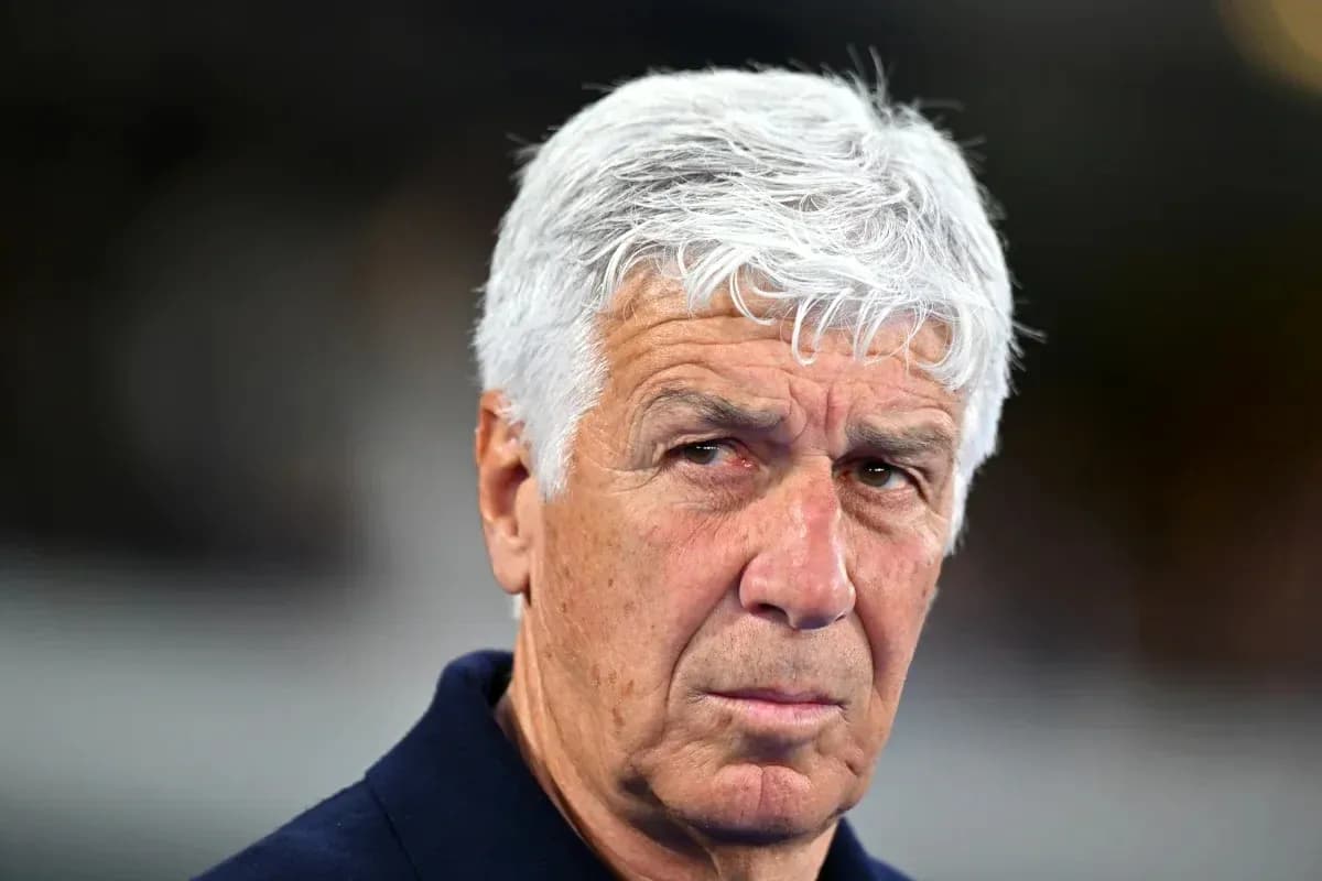 Football coach looking intently during a match