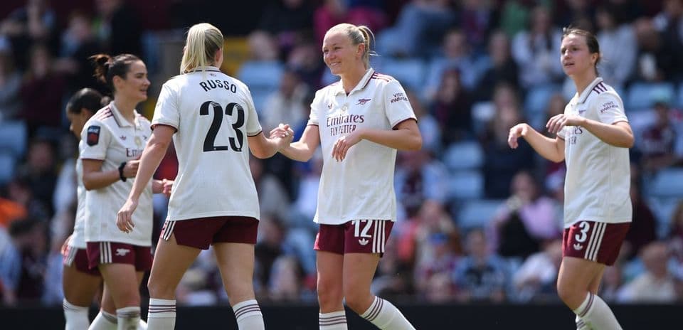 Arsenal women celebrating a goal on the pitch