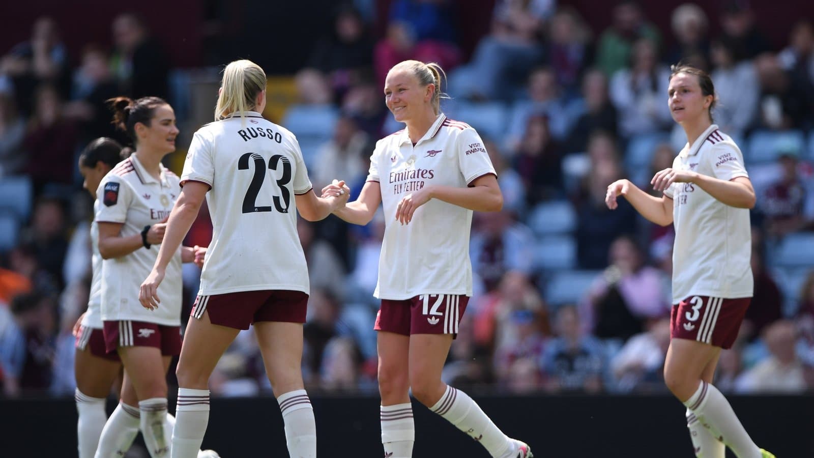 Arsenal women celebrating a goal on the pitch