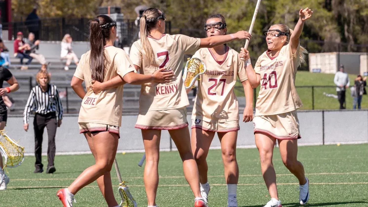 Lacrosse players celebrating on the field