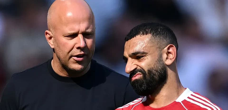 Two men talking on the football field