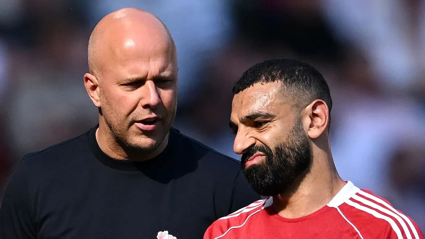 Two men talking on the football field