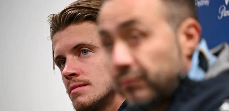 Two individuals at a press conference setting