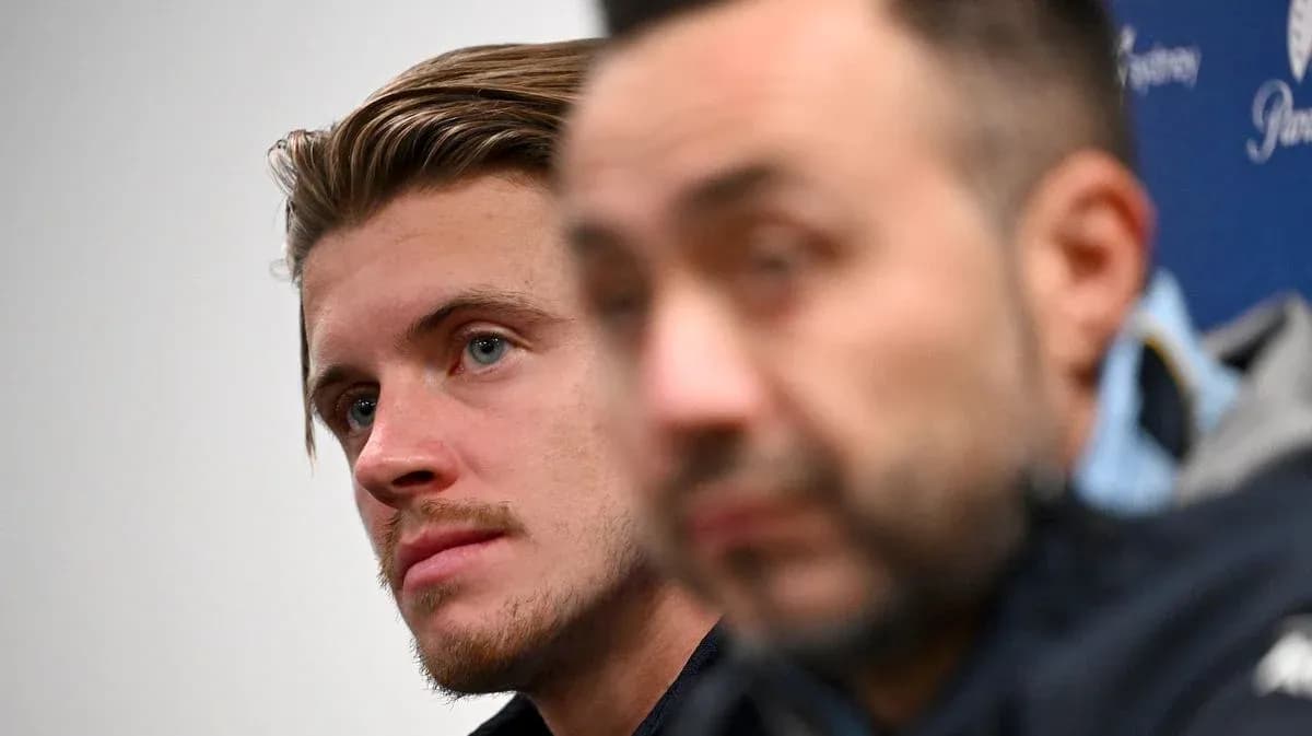 Two individuals at a press conference setting Two individuals at a press conference setting