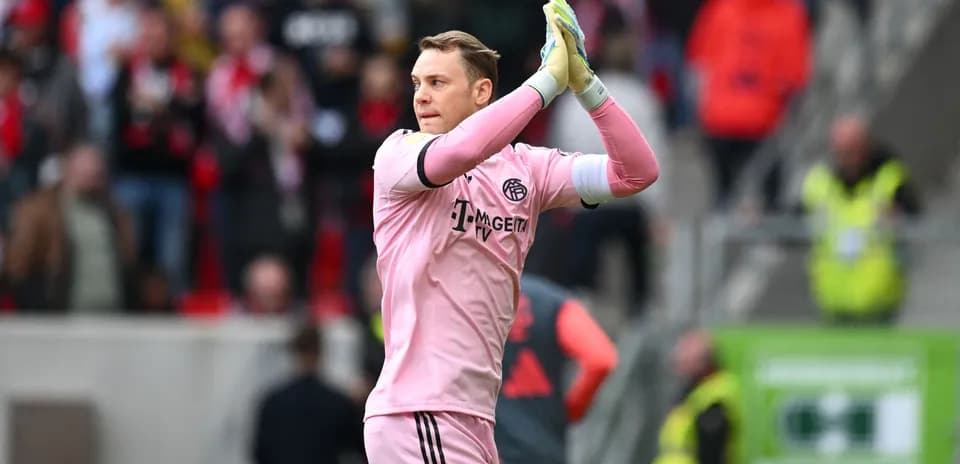 Goalkeeper applauding fans after match in pink kit