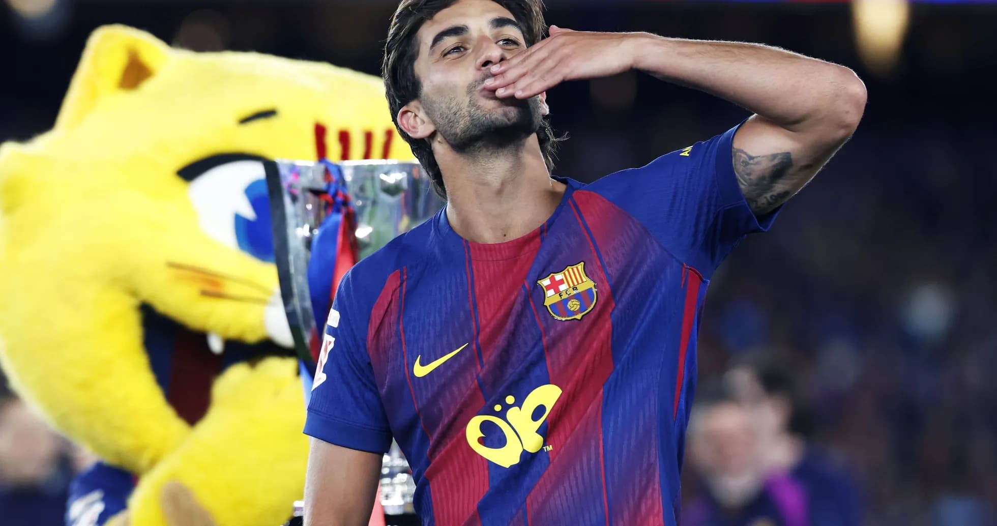 Barcelona player celebrating with trophy and mascot Barcelona player celebrating with trophy and mascot