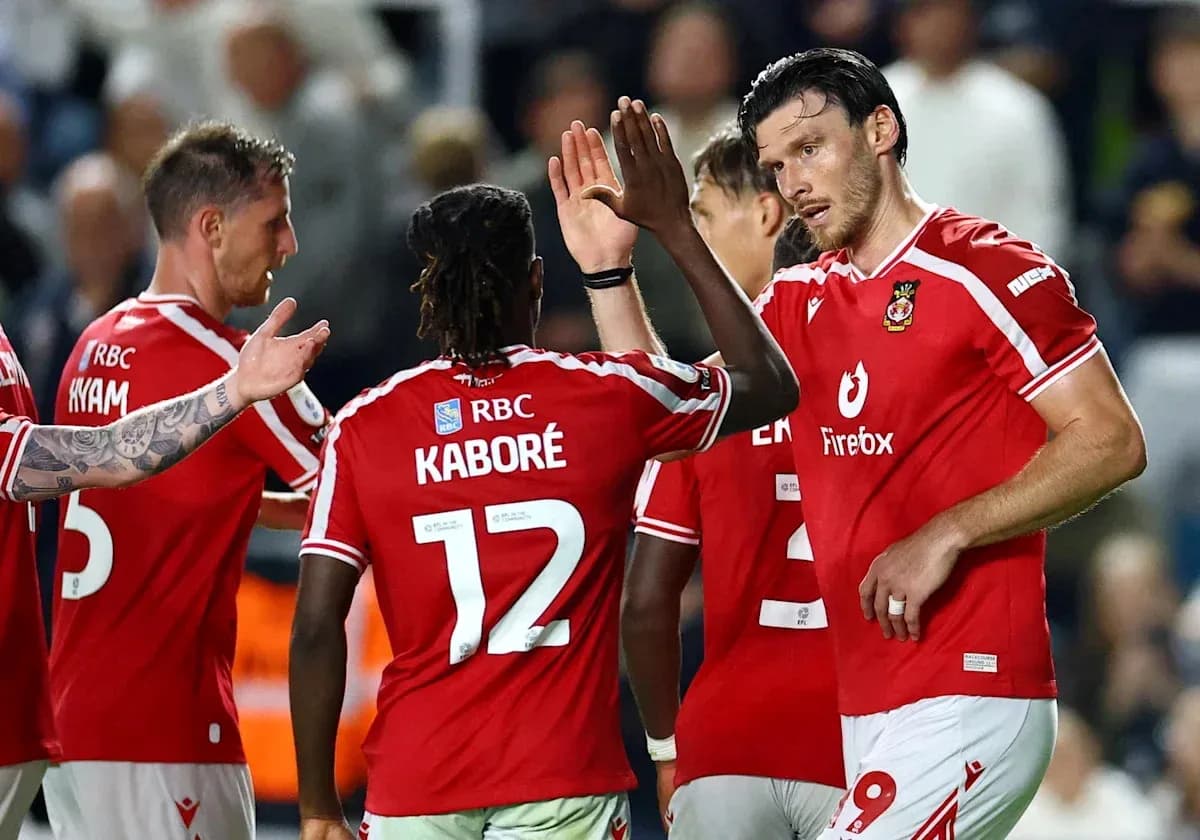 Football players celebrating a goal in red jerseys Football players celebrating a goal in red jerseys