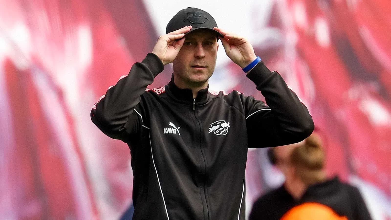 Coach adjusting cap during match warm-up Coach adjusting cap during match warm-up