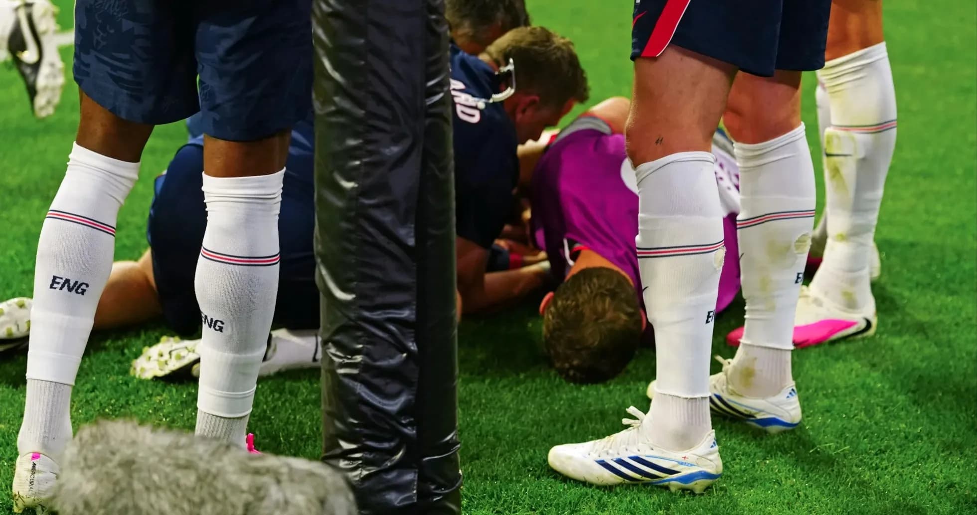 Players surrounding injured teammate on the field Players surrounding injured teammate on the field