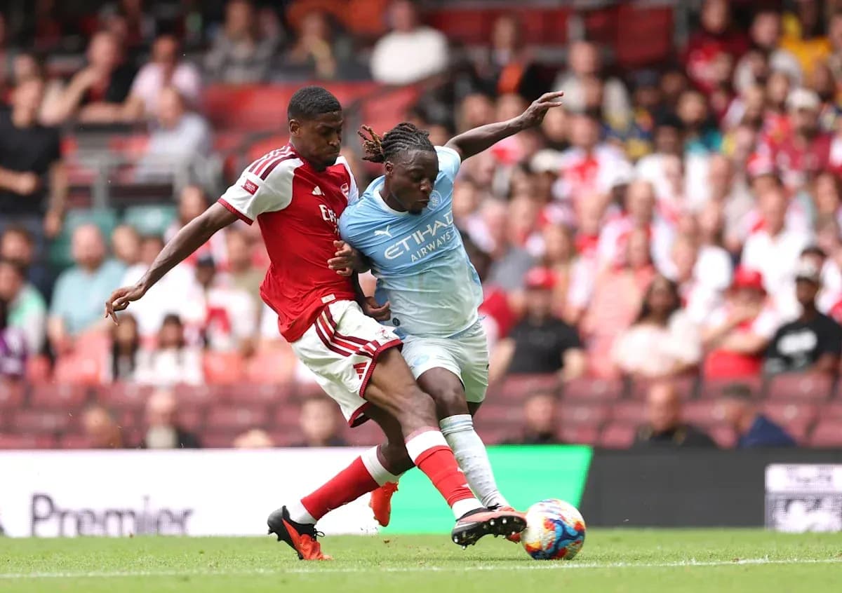 Two players contesting for the ball during match Two players contesting for the ball during match