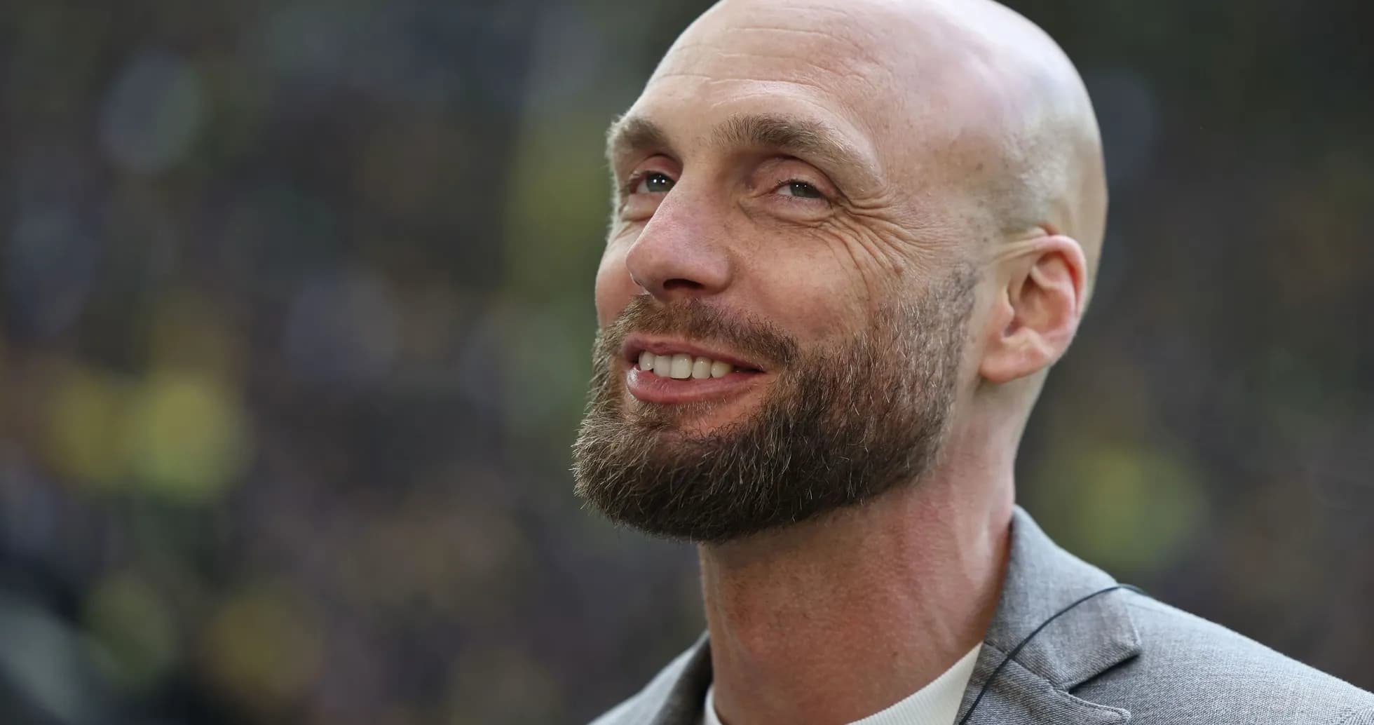 Bald man with beard smiling in a suit Bald man with beard smiling in a suit