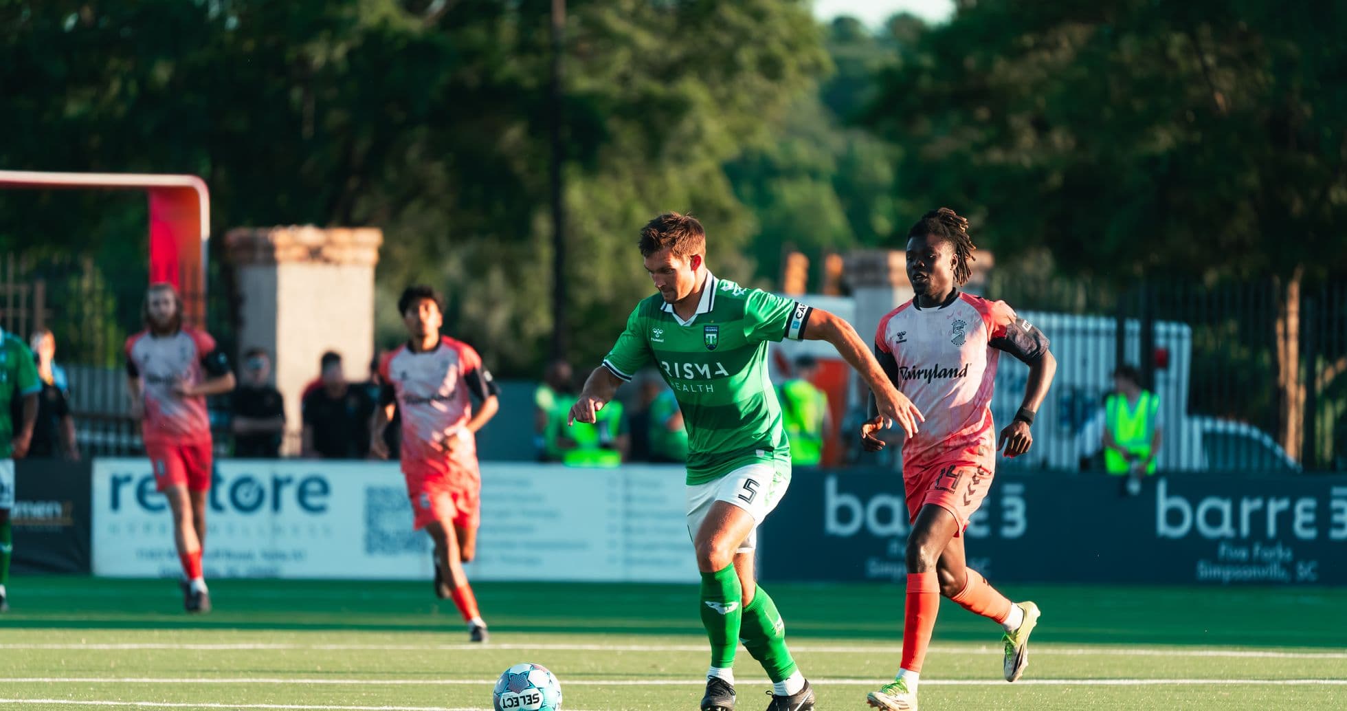 Greenville Triumph futbolçusu topu idarə edir Greenville Triumph futbolçusu topu idarə edir