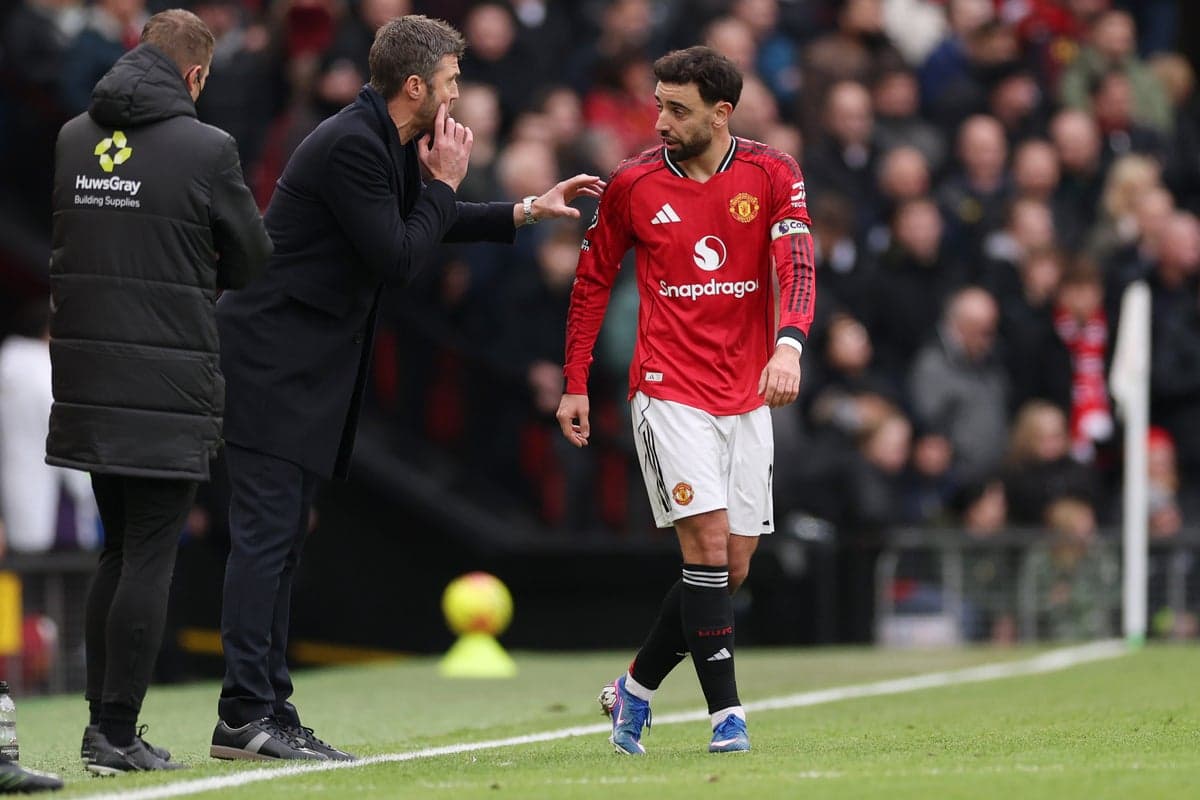 Bruno Fernandes receiving instructions from coach during match Bruno Fernandes receiving instructions from coach during match