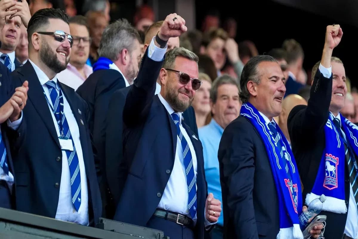 Fans celebrating in stands wearing team scarves Fans celebrating in stands wearing team scarves