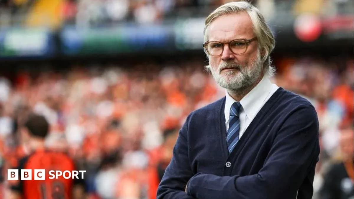 Coach observing match with arms crossed in stadium Coach observing match with arms crossed in stadium