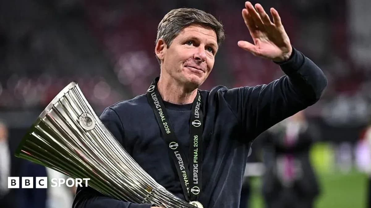 Coach holding trophy and waving after match Coach holding trophy and waving after match