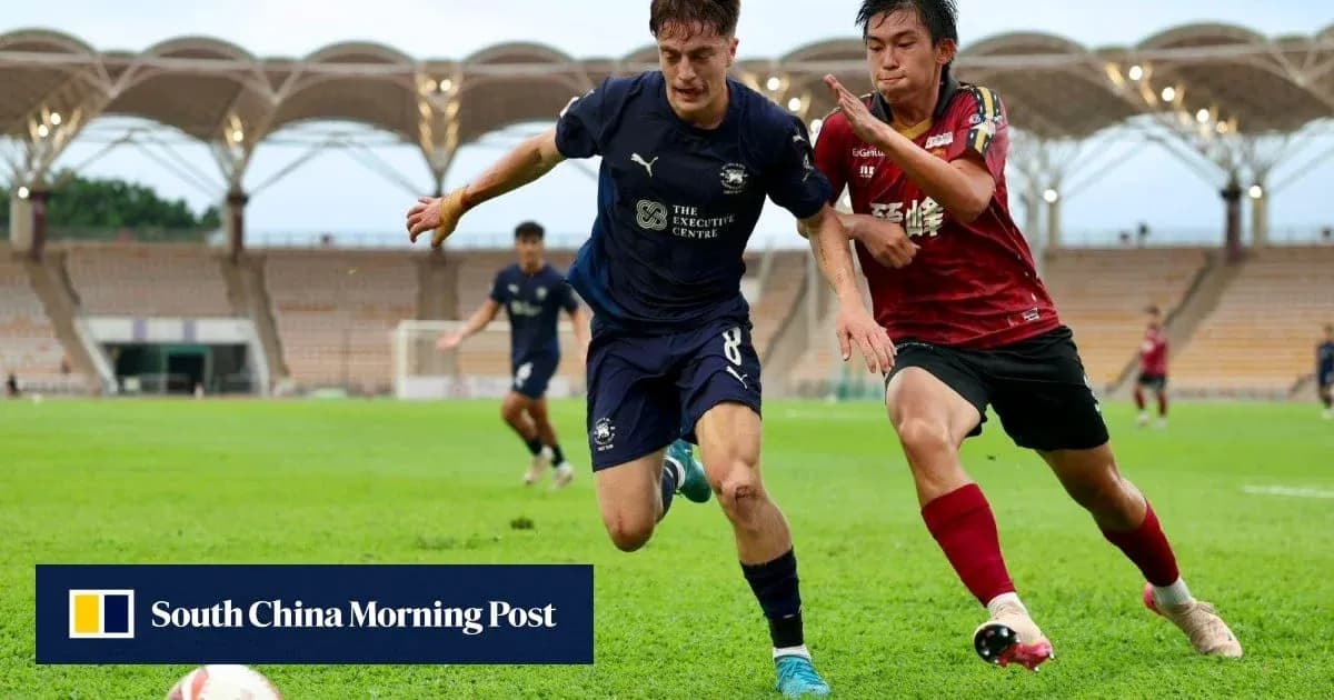 Player in blue jersey evading opponent on field Player in blue jersey evading opponent on field
