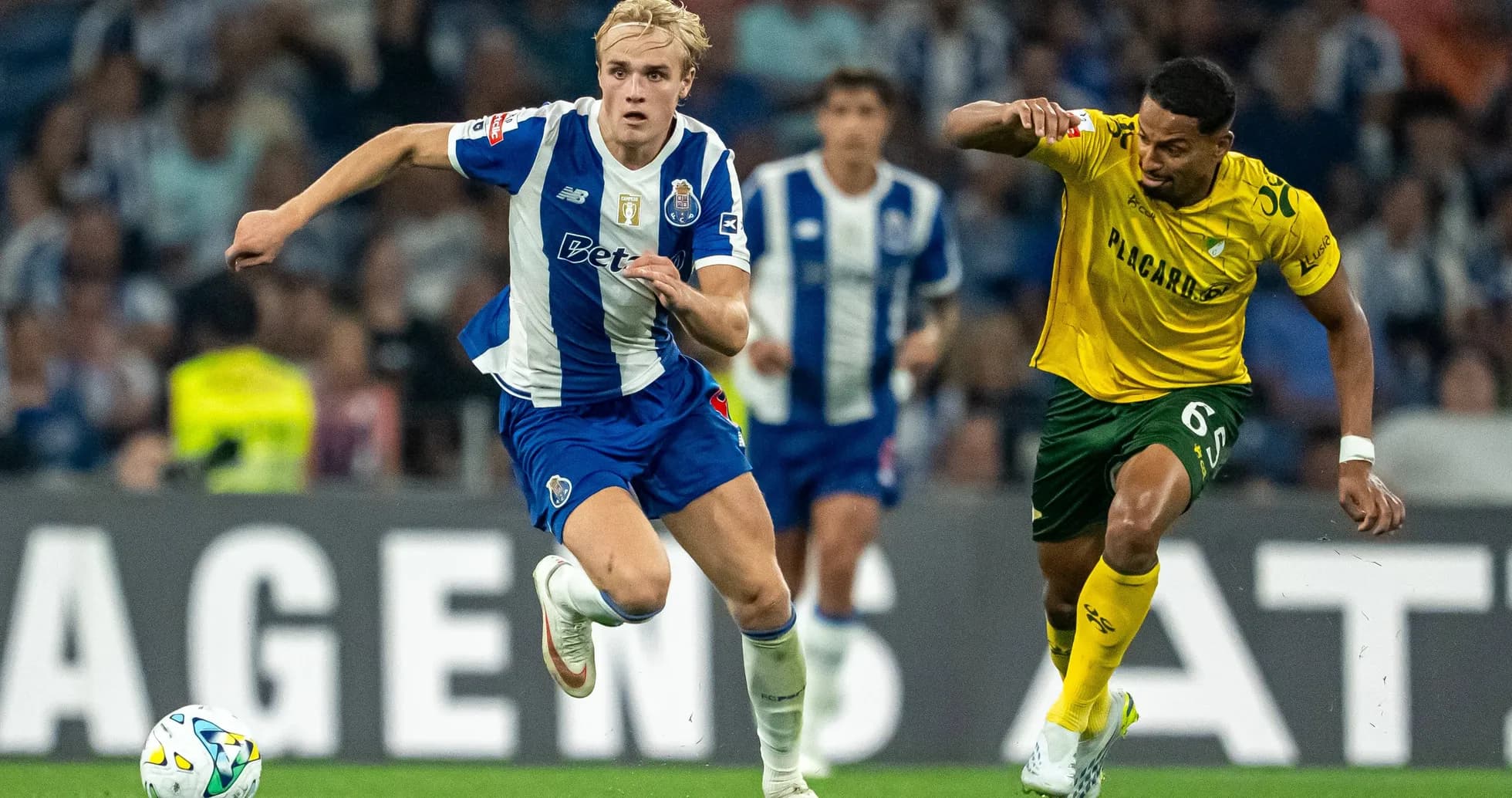 Porto player sprinting with ball, opponent chasing Porto player sprinting with ball, opponent chasing