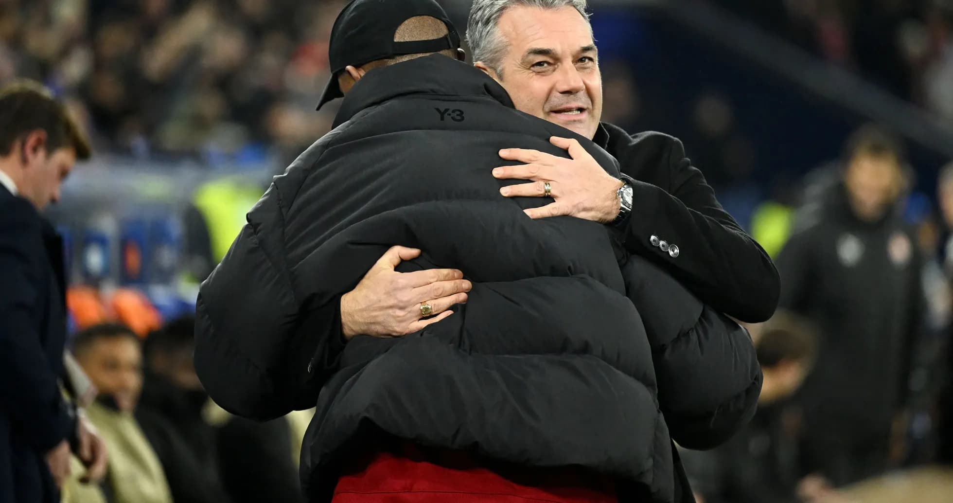Coaches embracing on the sidelines after match Coaches embracing on the sidelines after match