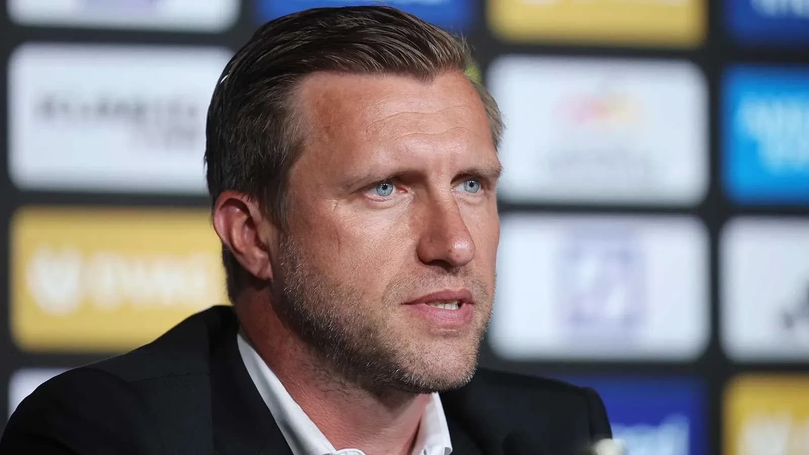 Men's football manager speaking at press conference Men's football manager speaking at press conference